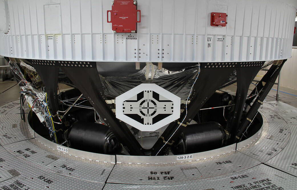 Technicians add a “target” to the instrumentation of NASA’s Artemis II rocket